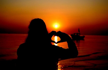 Locals silhouetted at sunset in Bangladesh's Patuakhali